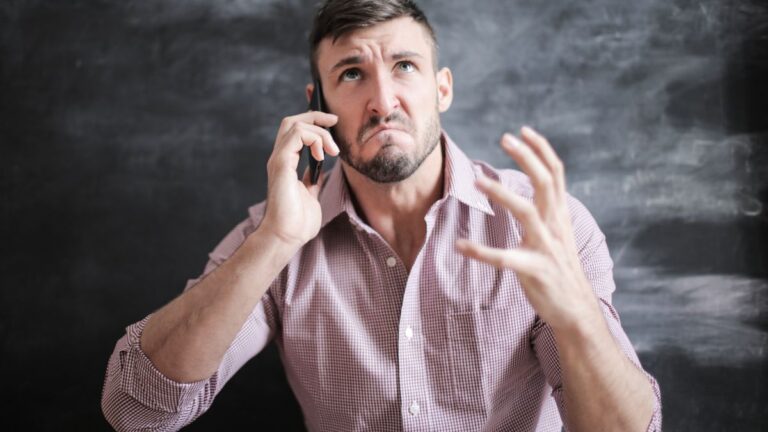 Frustrated man checking his phone after photos disappeared