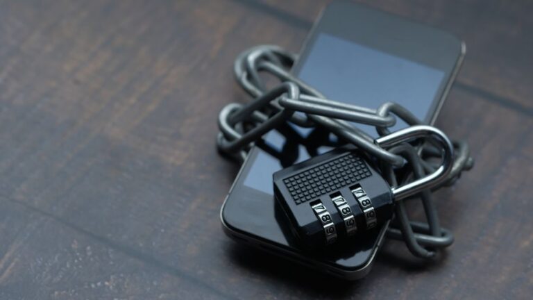 A smartphone secured with a chain and padlock representing private storage