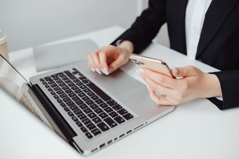 Hands typing on a laptop to recover a hacked Facebook account