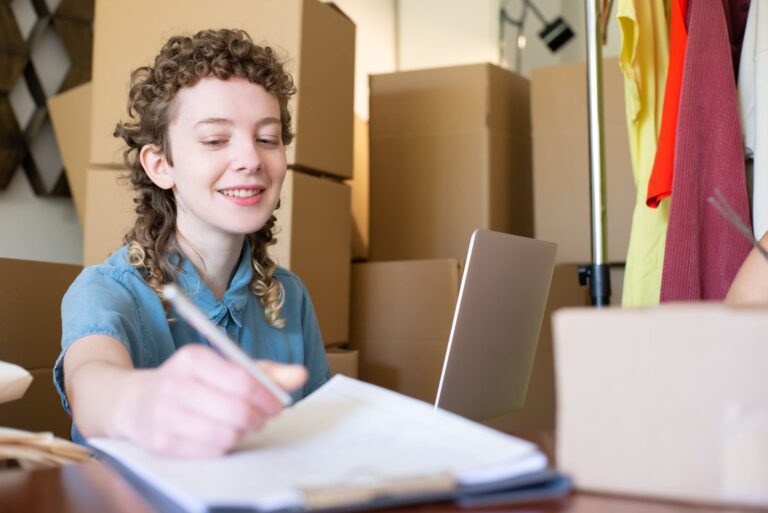 Small business seller managing orders with a laptop