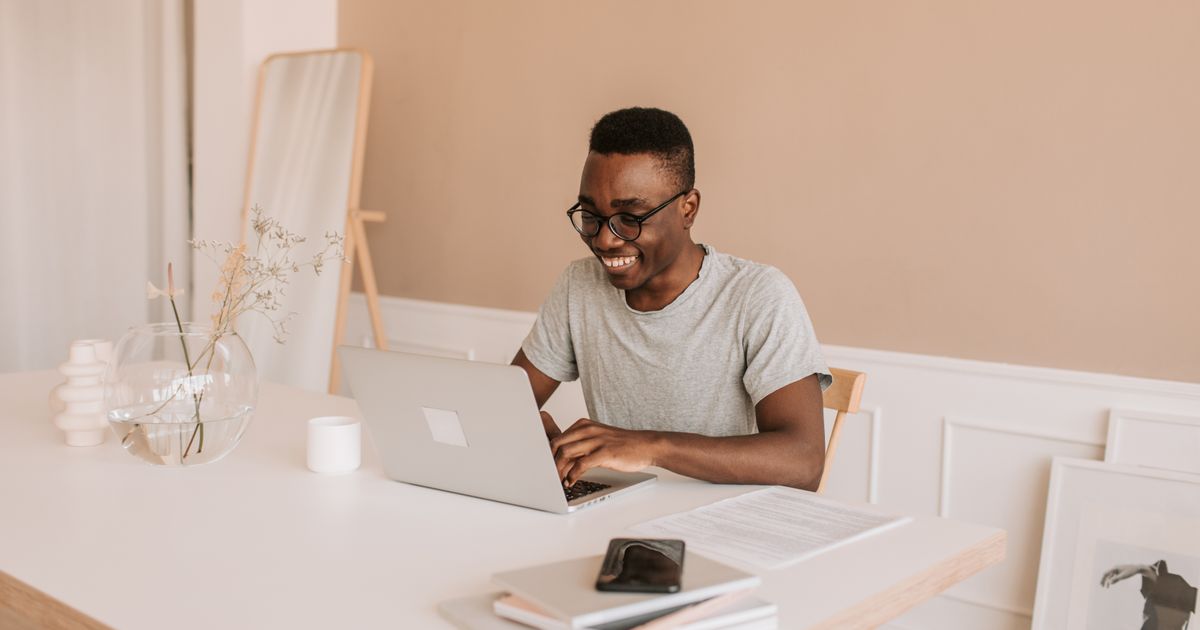 Person setting up a new free email account on a laptop at home