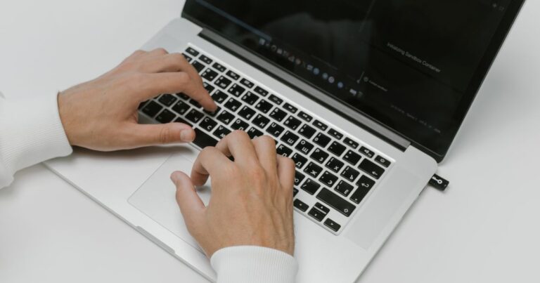 Hands on a laptop choosing the right security tools